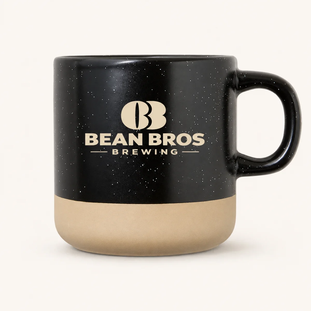Black speckled Bean Bros mug with sand-colored base and cream logo