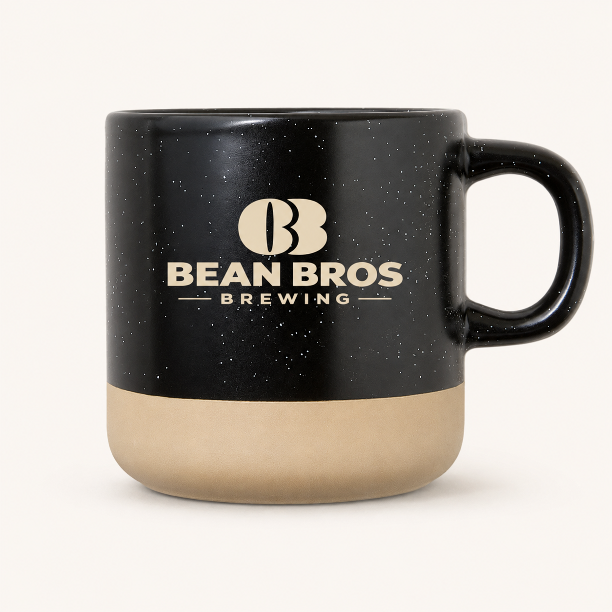 Black speckled Bean Bros mug with sand-colored base and cream logo